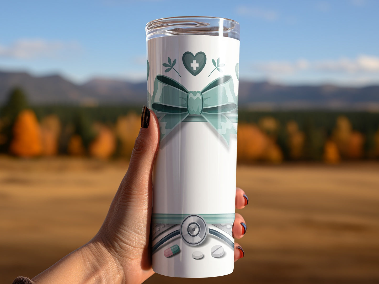 White tumbler with green ribbon, heart, and medical symbols.