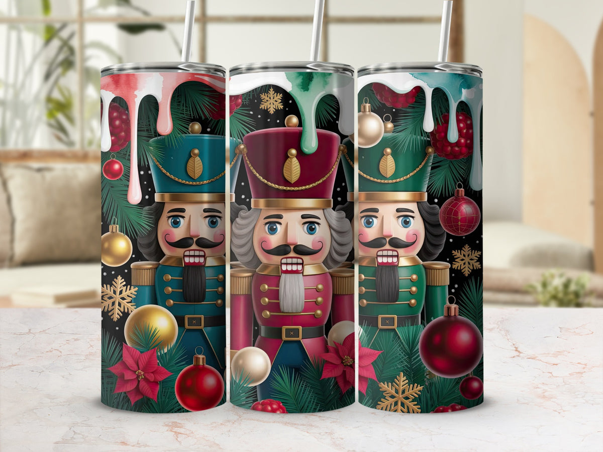 Three stainless steel tumblers feature a festive Christmas nutcracker pattern with pine branches and ornaments.