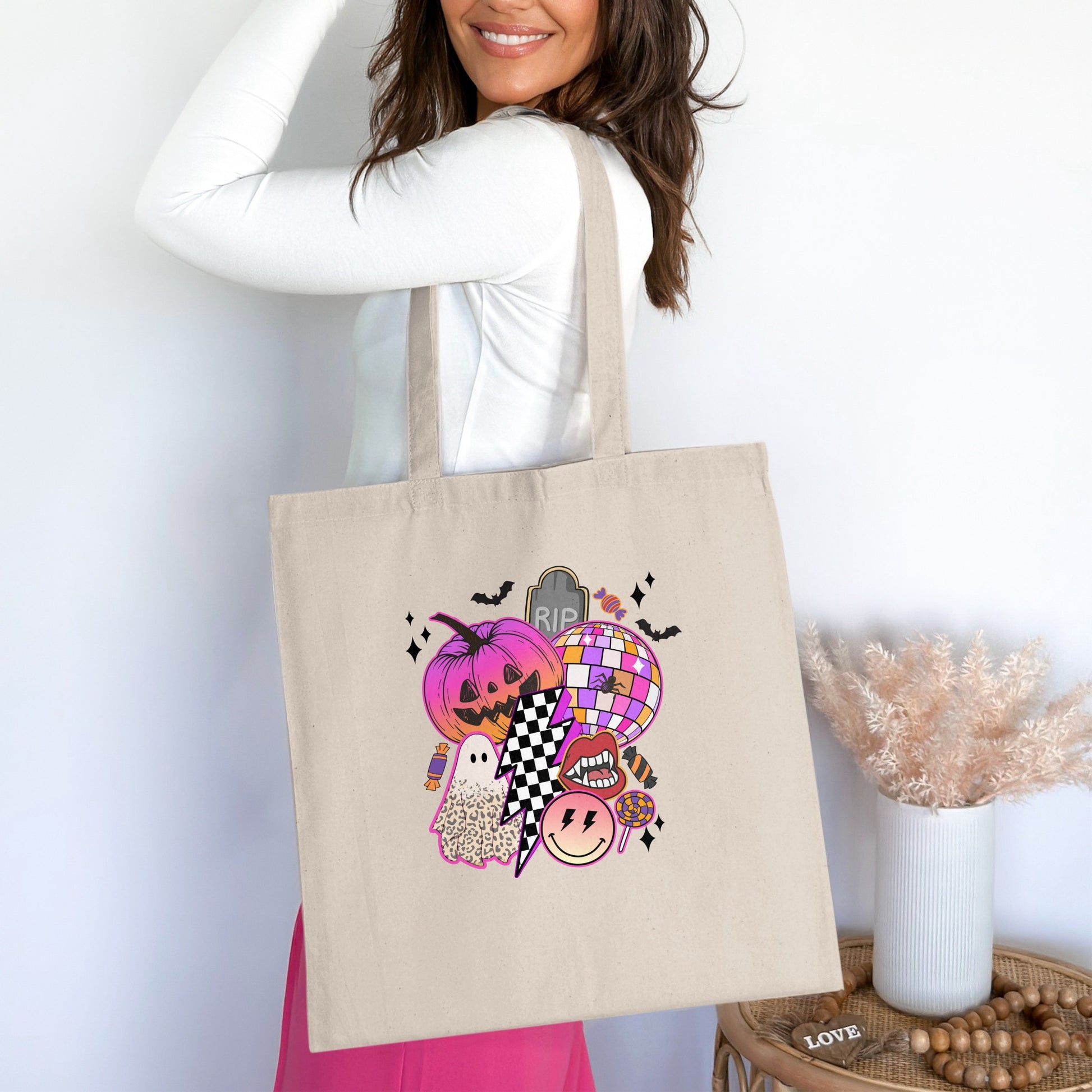Tote bag featuring a Halloween collage with a pumpkin, ghost, disco ball, and lips.