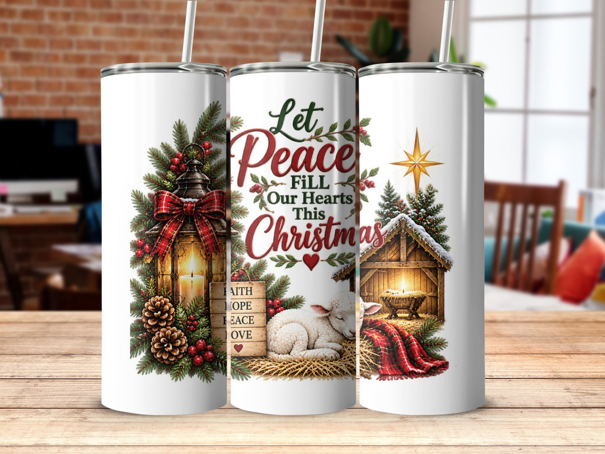 Three white tumblers with straws display a Christmas theme, including a lantern, text, a nativity scene, and pine foliage.