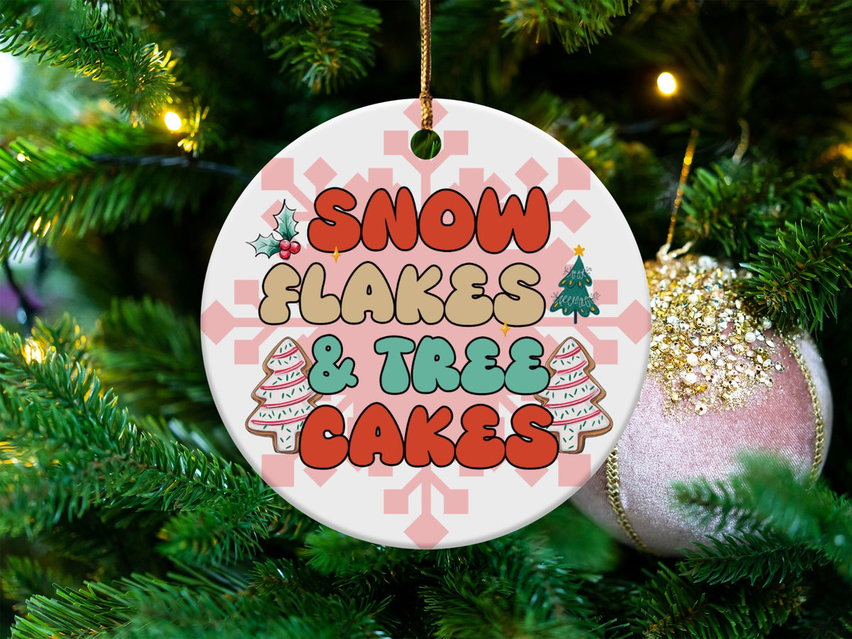 Round ceramic ornament with text "Snowflakes & Trees Cakes" and festive designs.