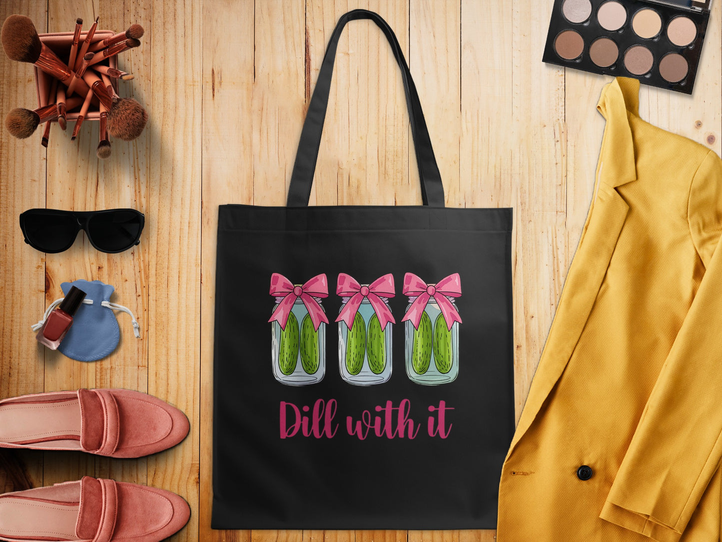 Black tote bag with three jars of pickles and text "Dill with it".