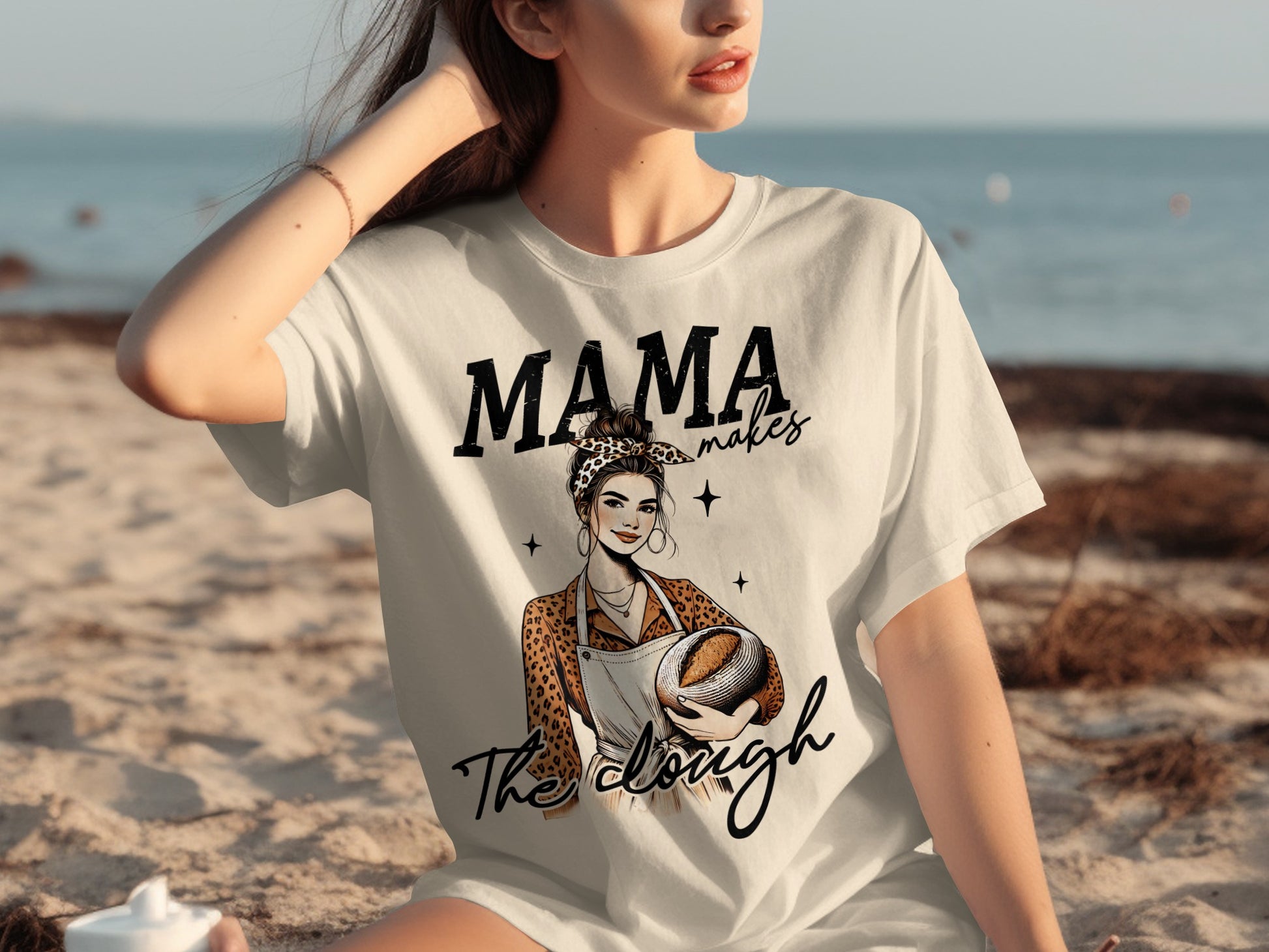 White graphic t-shirt with "Mama makes The dough" and baking design.