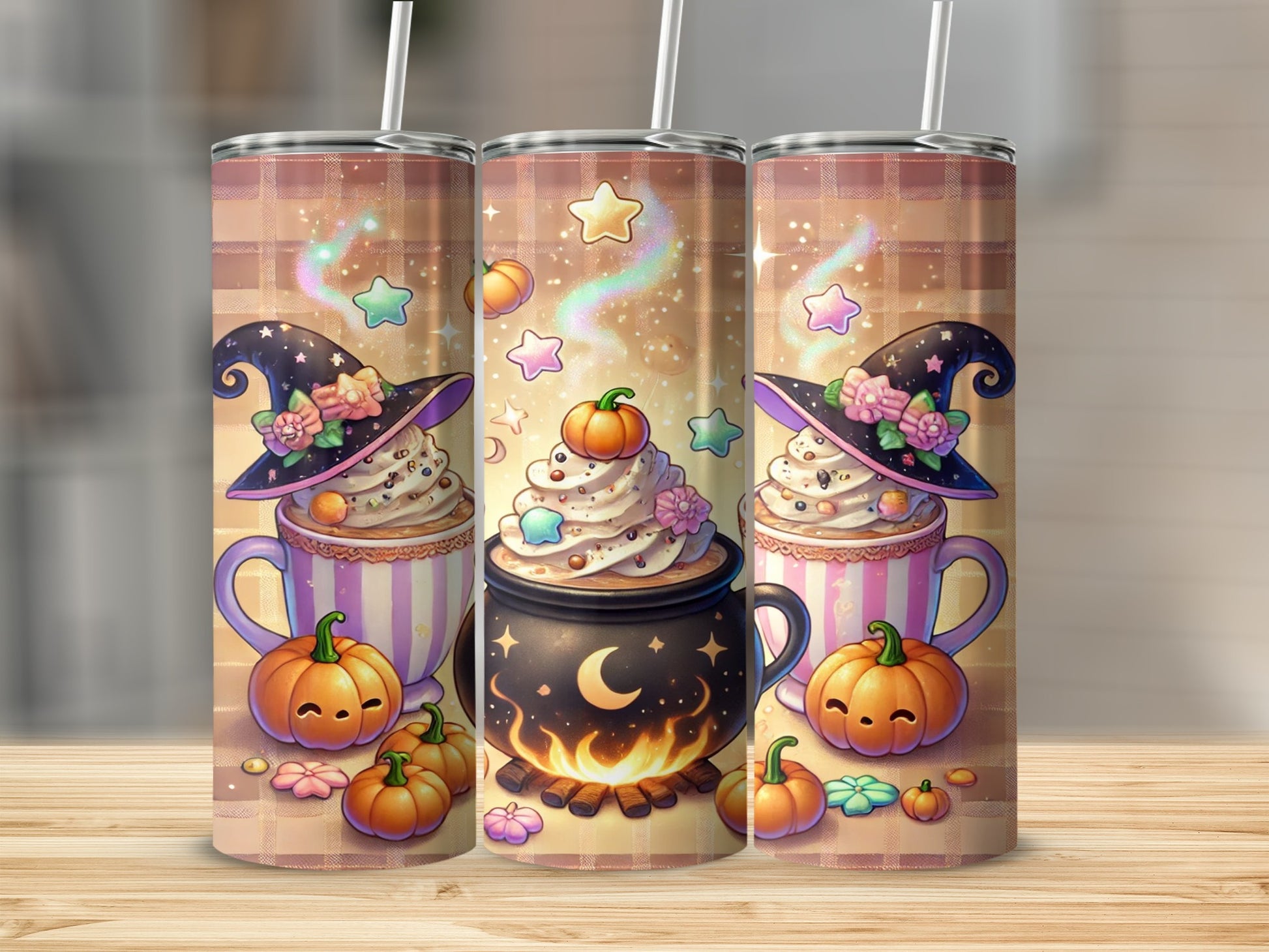 Three tumblers with witch hat, pumpkin, and starry hot chocolate designs.