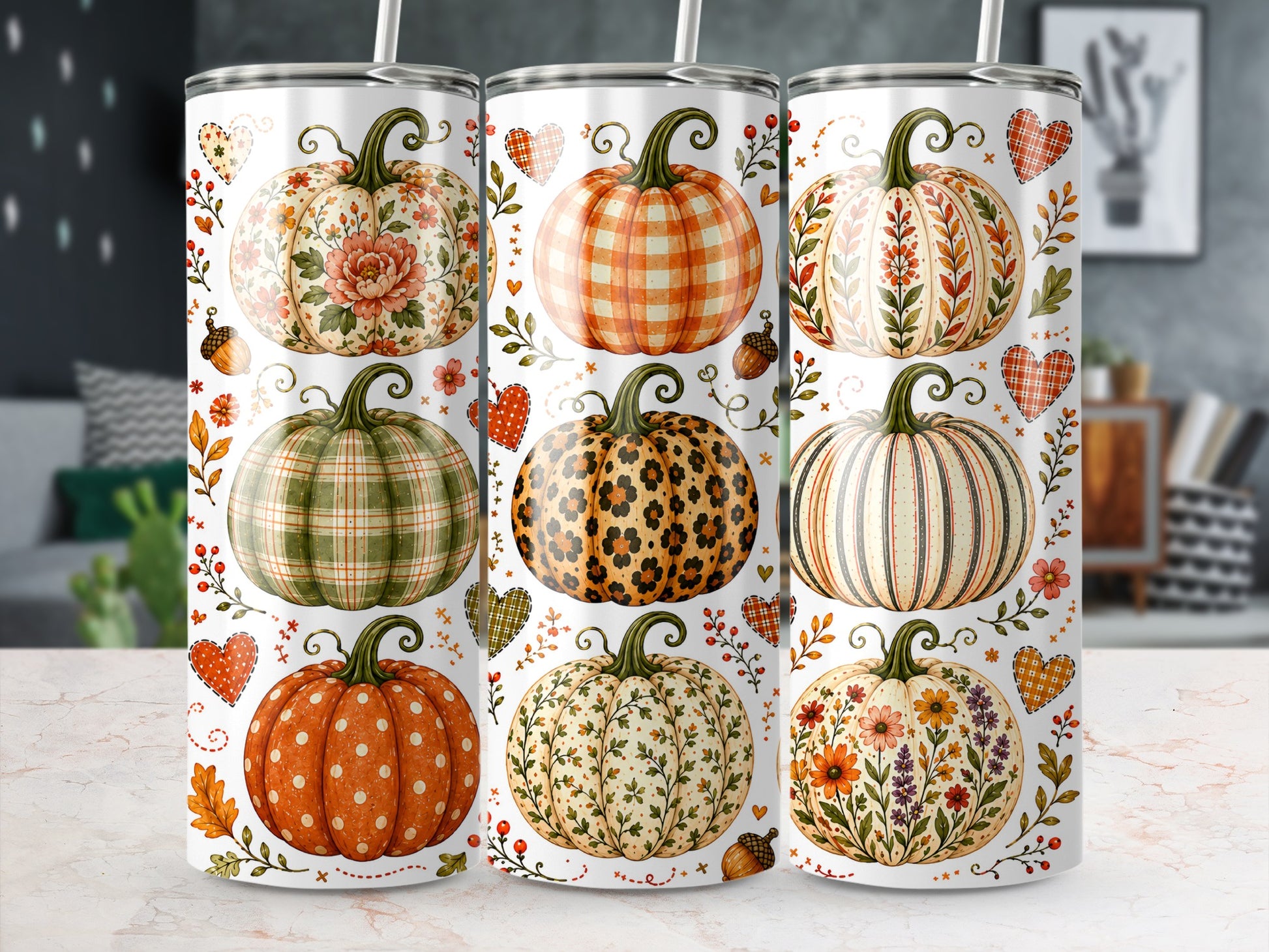 Three tumblers with various fall pumpkin designs and accents.