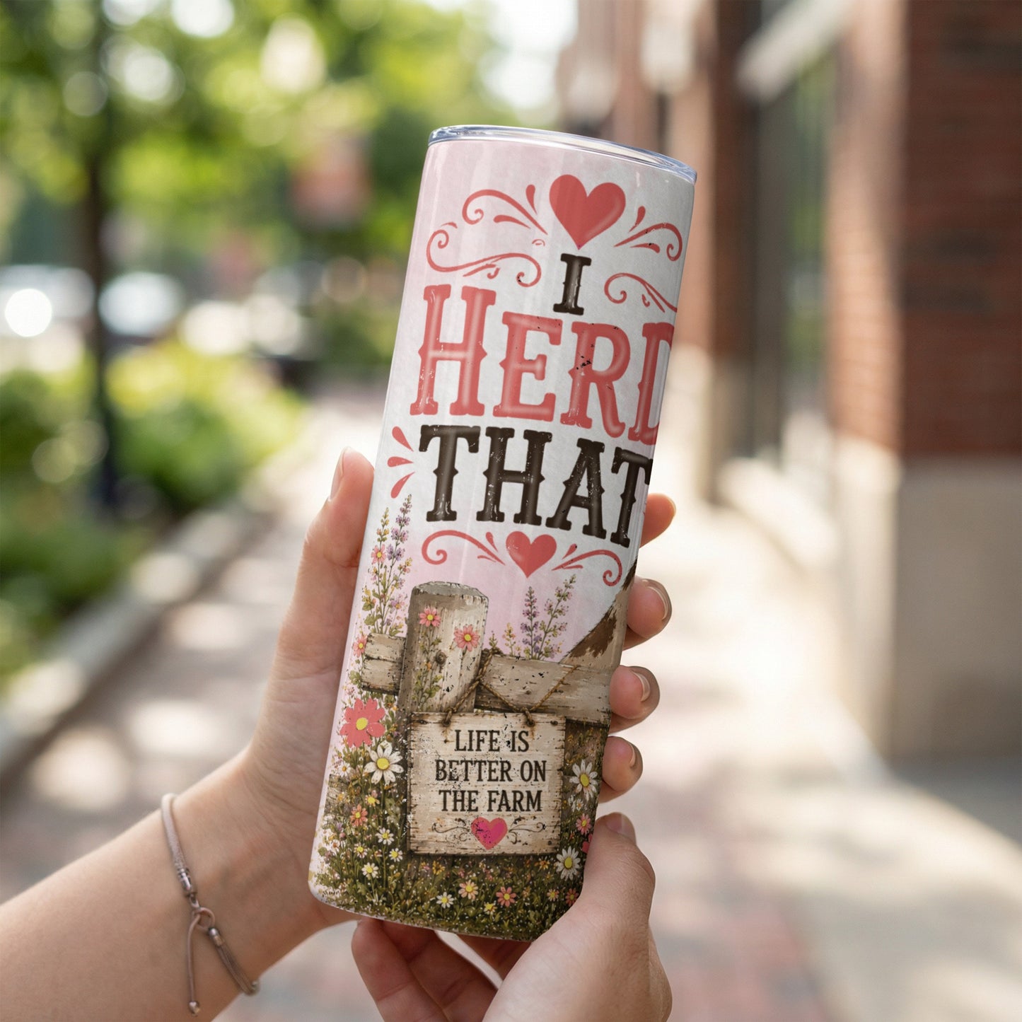Tumbler with "I herd that" and "Life is better on the farm" text.