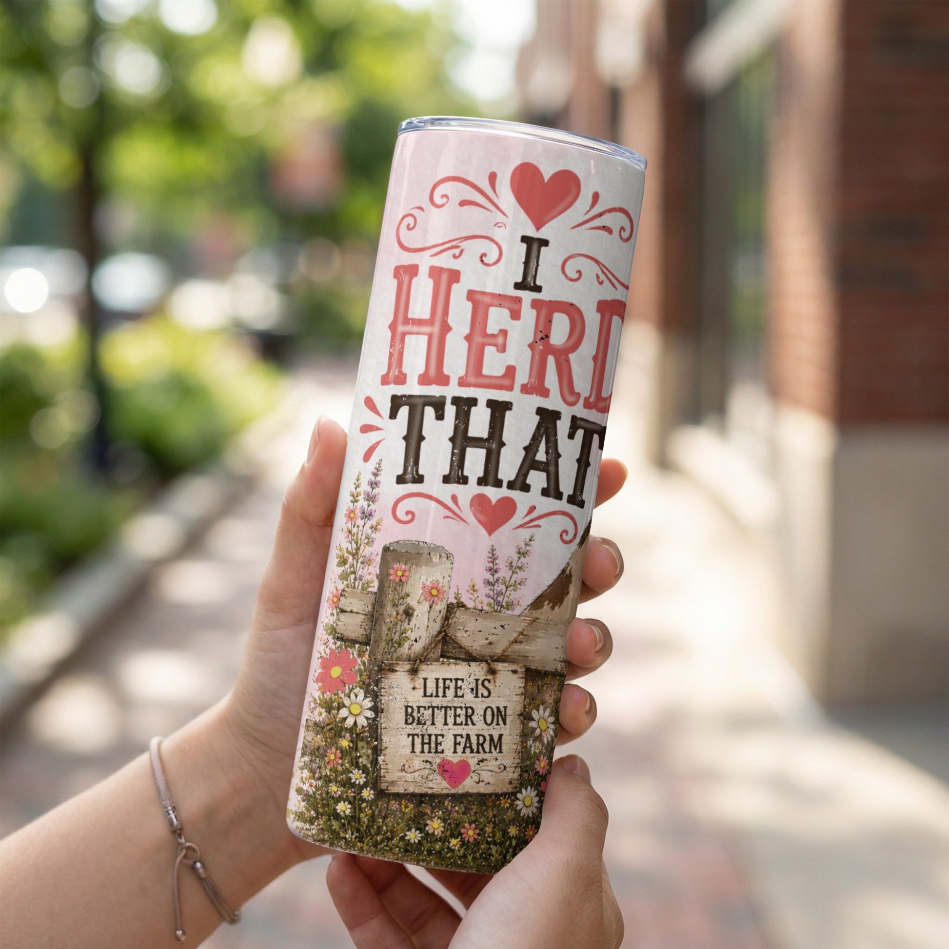 Tumbler with "I herd that" and "Life is better on the farm" text.