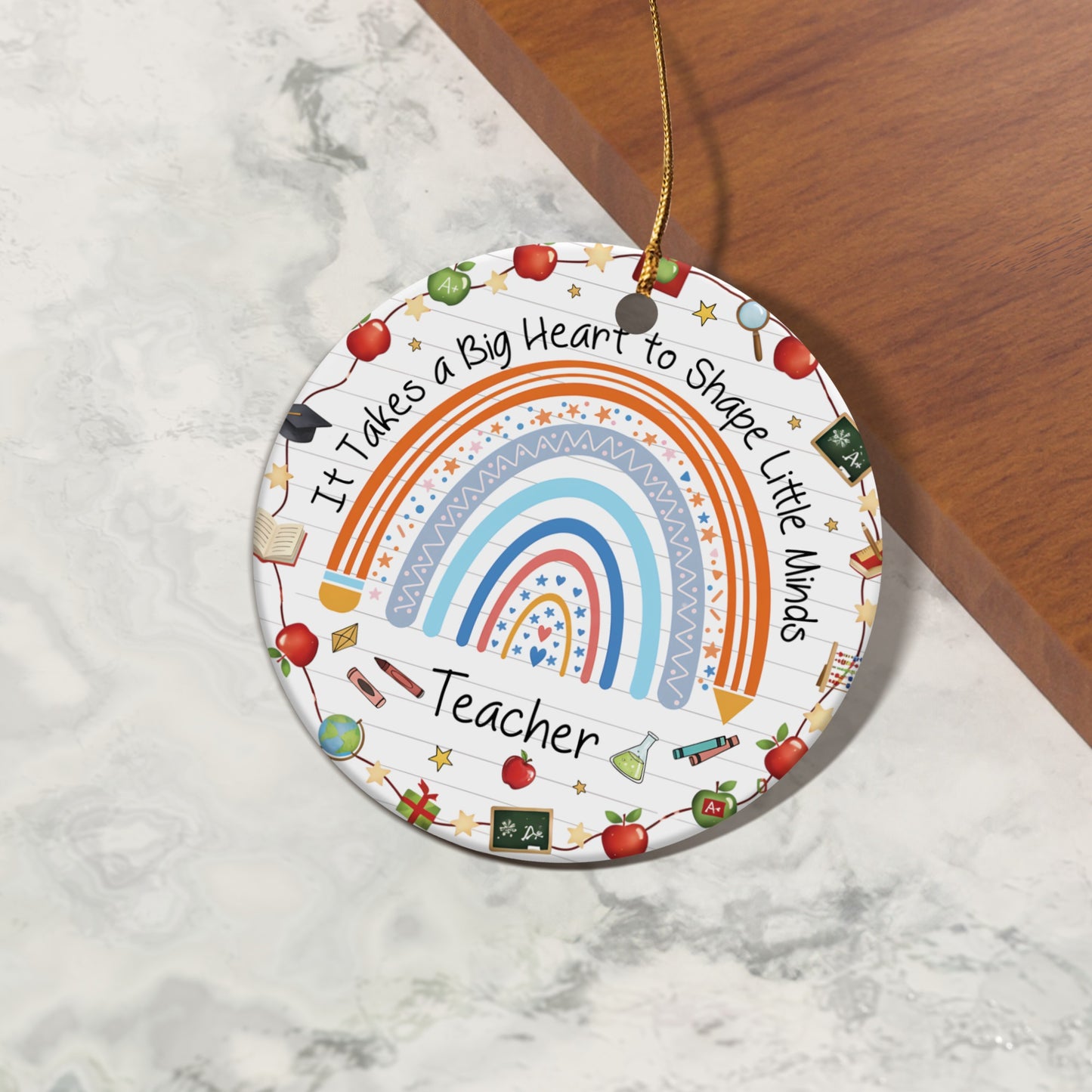 Ornament with rainbow and text "It Takes a Big Heart to Shape Little Minds Teacher."