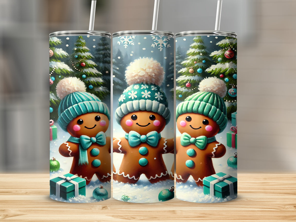 Three tall travel tumblers display a winter wonderland scene featuring cheerful gingerbread figures wearing teal beanies and matching scarves.