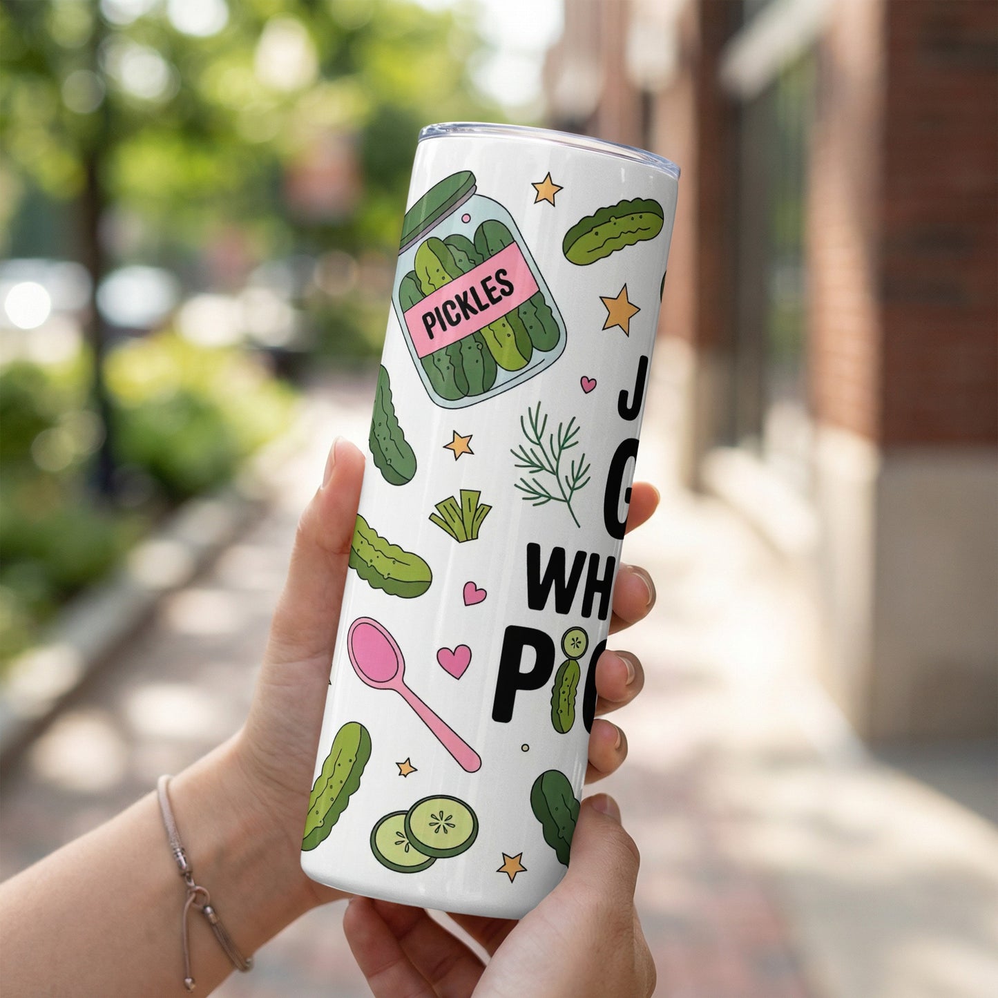 Tumbler with pickles, dill sprigs, and a spoon illustration.