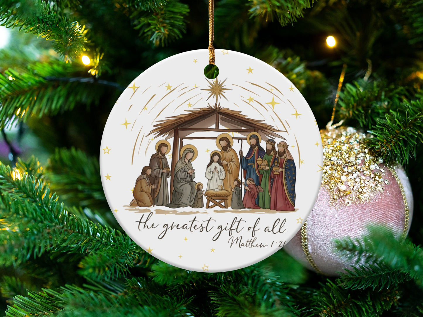 Nativity scene ornament with text "the greatest gift of all Matthew 1:21".