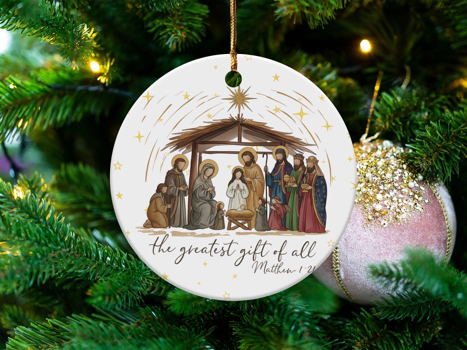 Nativity scene ornament with text "the greatest gift of all Matthew 1:21".