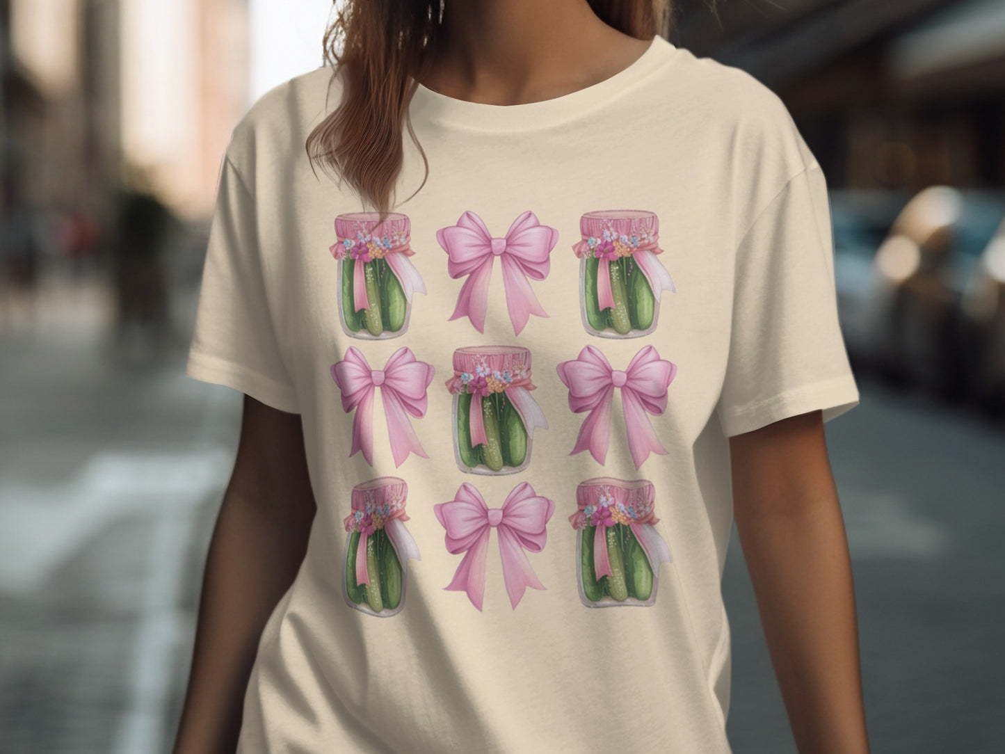 T-shirt with nine jars of pickles adorned with pink bows.