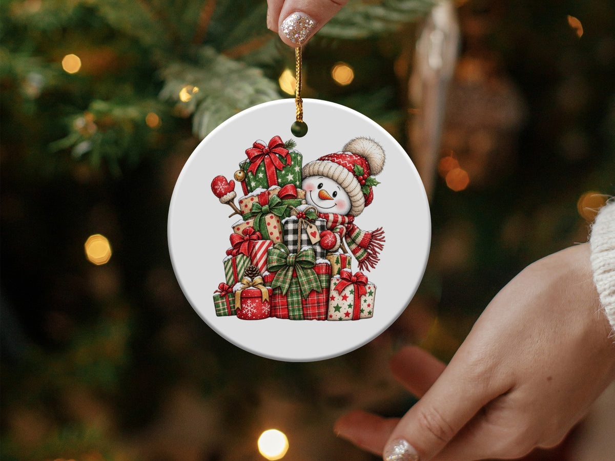 Round Christmas ornament featuring a snowman holding a pile of gifts.