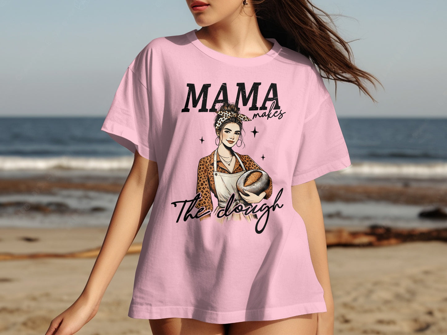 Pink t-shirt with "Mama Makes The Dough" and leopard print baker illustration.