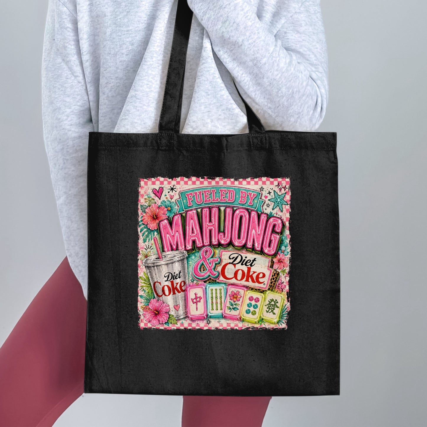 Black tote bag with a graphic saying "Fueled by Mahjong & Diet Coke" and mahjong tiles.