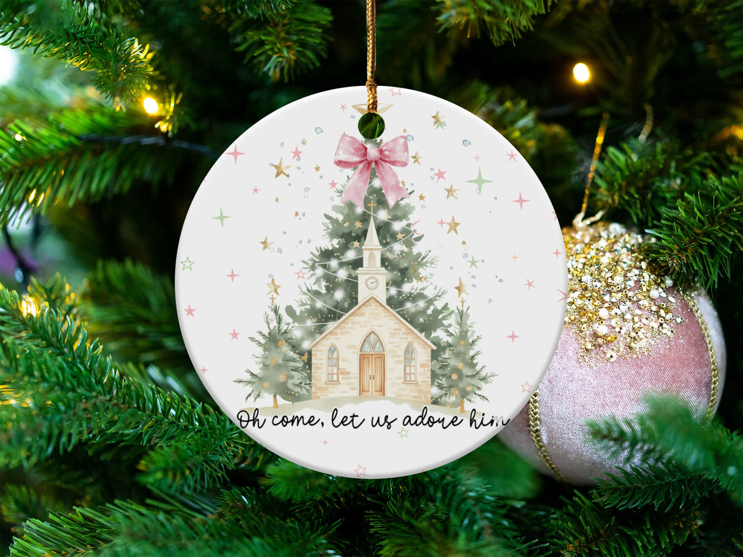 Christmas ornament with church scene and "Oh come, let us adore him" text.