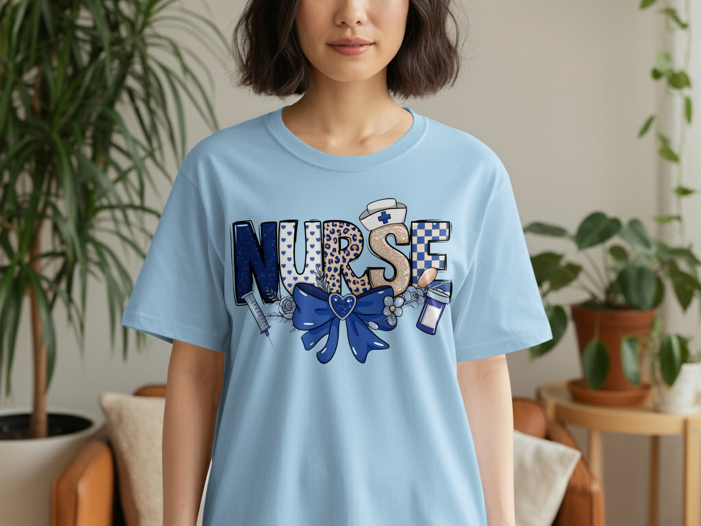 Light blue t-shirt with "NURSE" in colorful, patterned letters and a stethoscope.