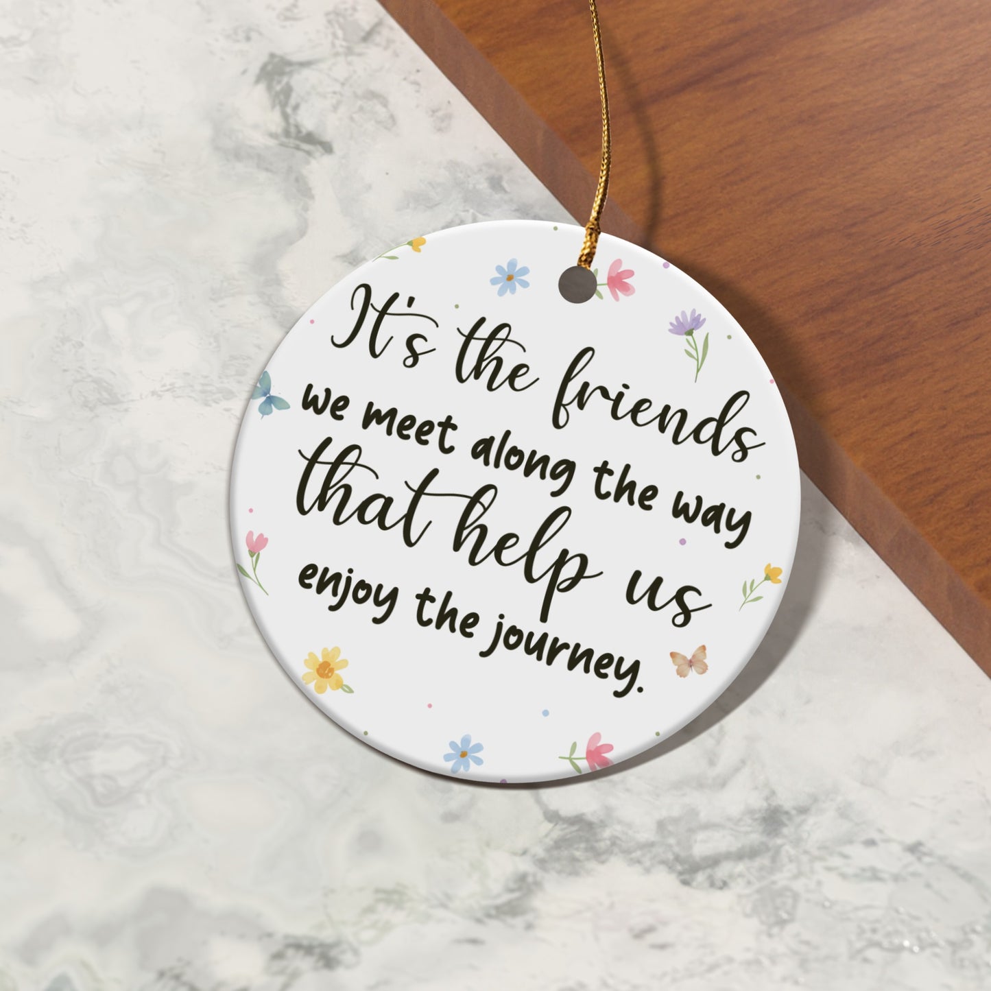 Round ornament with quote "It's the friends we meet along the way that help us enjoy the journey."