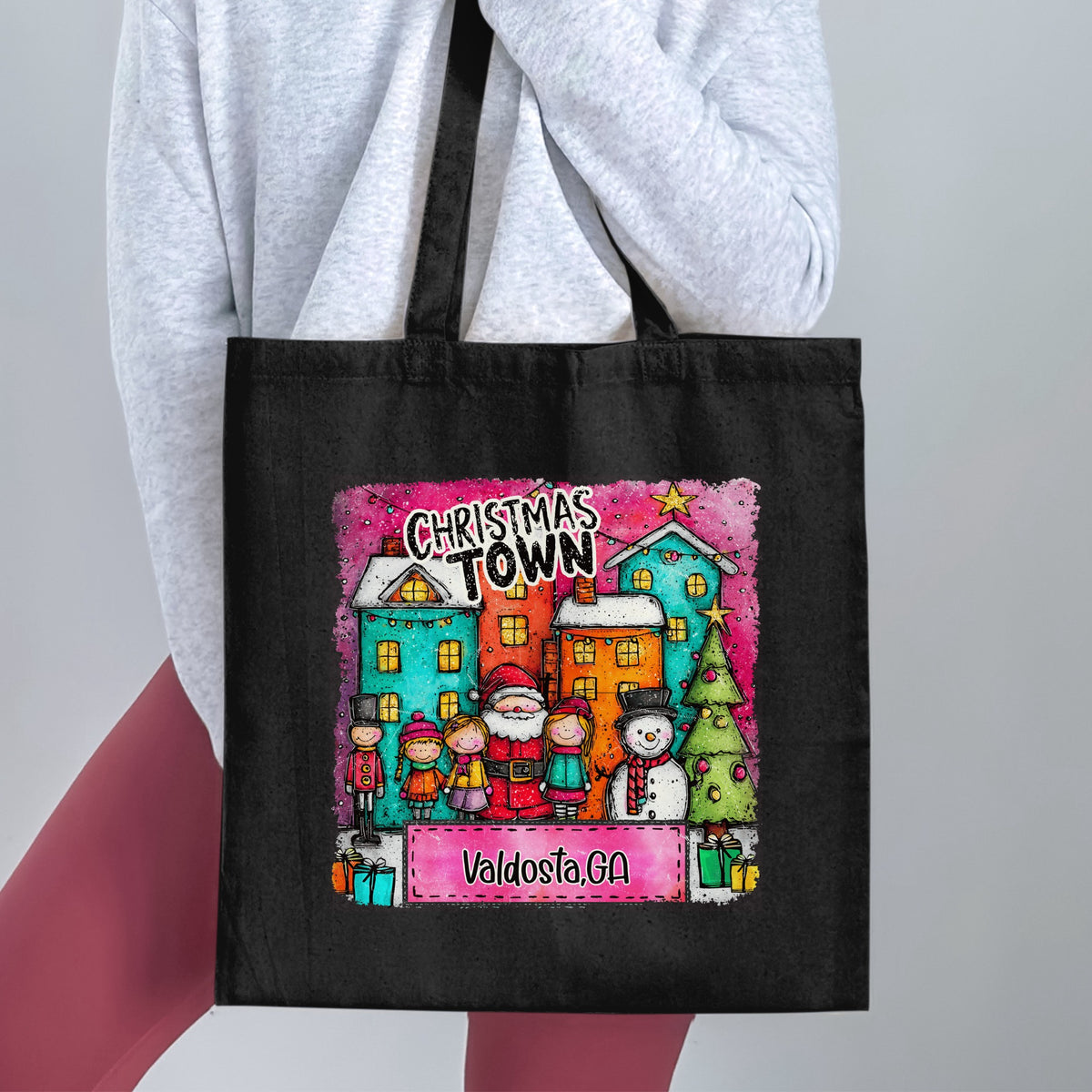 Black tote bag with "Christmas Town Valdosta, GA" design featuring Santa and festive characters.