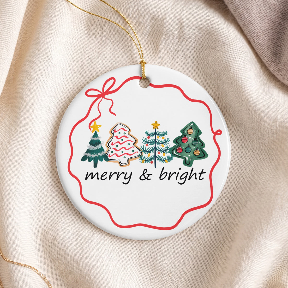 Round ornament with Christmas trees, gingerbread cookie, and "merry & bright" text.