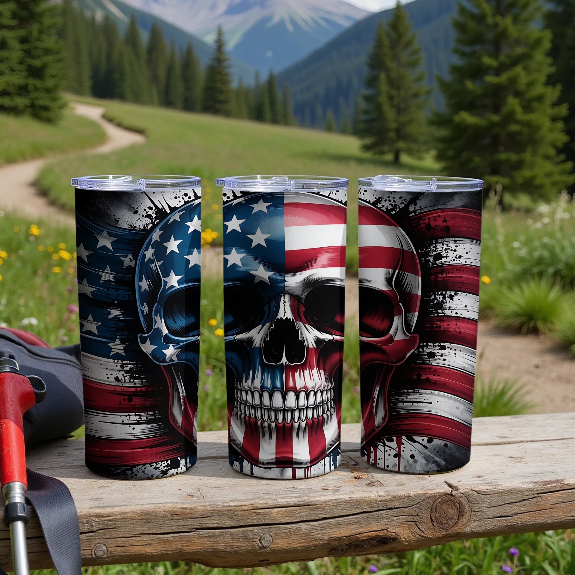 Three tumblers with American flag and skull designs on a wooden surface.