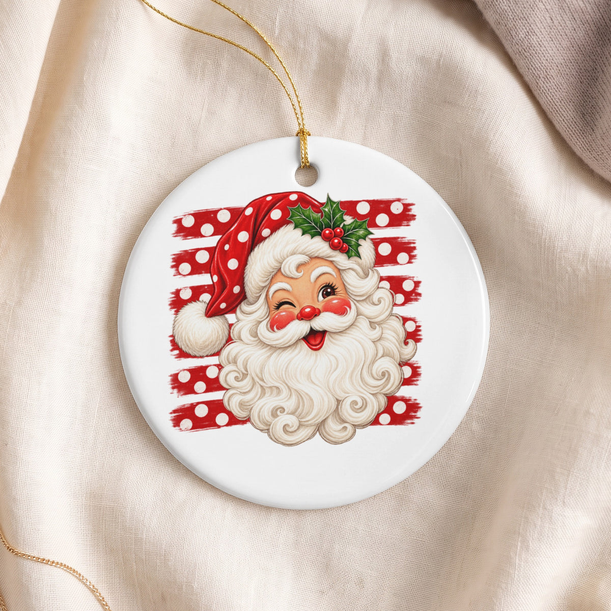 Round ornament featuring a vintage Santa Claus winking, with a polka dot hat and holly.