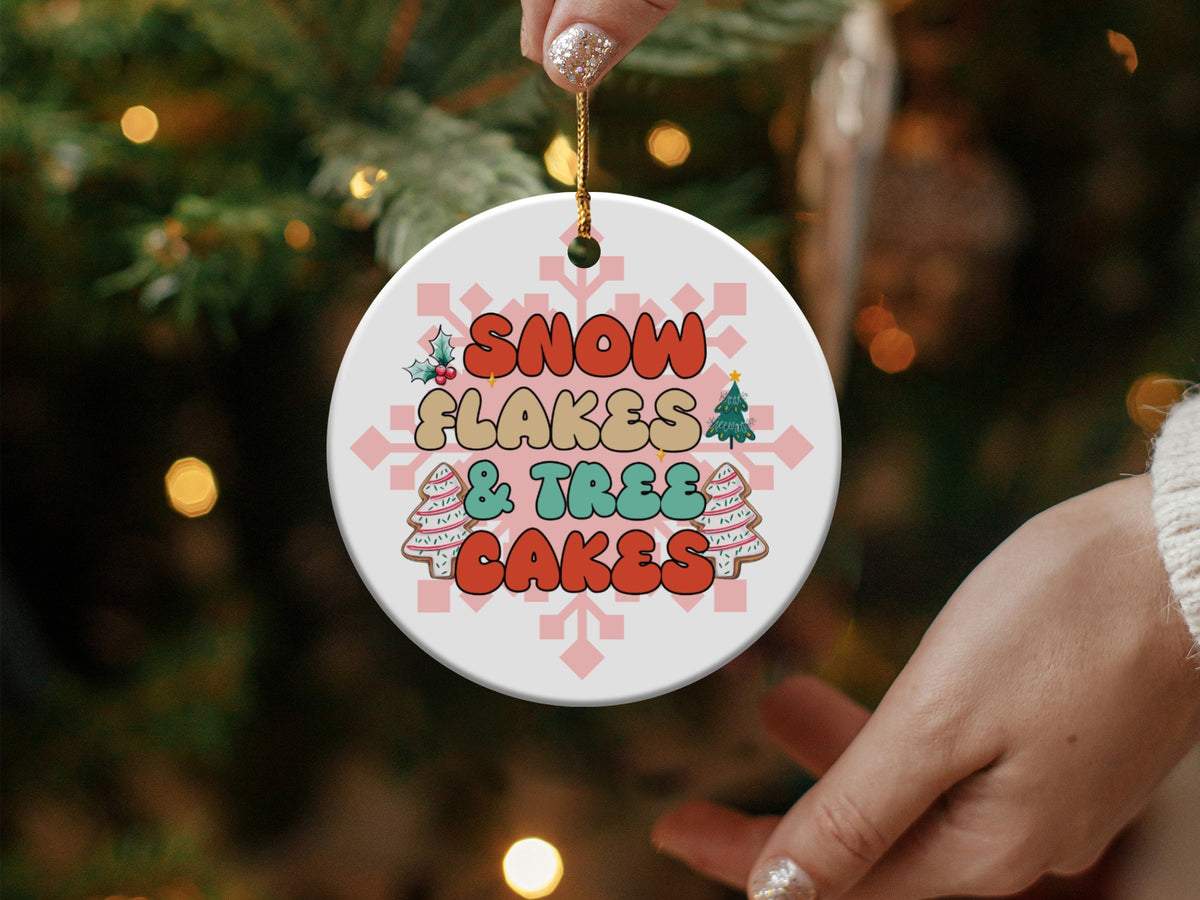 Round ornament with "Snowflakes & Trees Cakes" text and Christmas graphics.