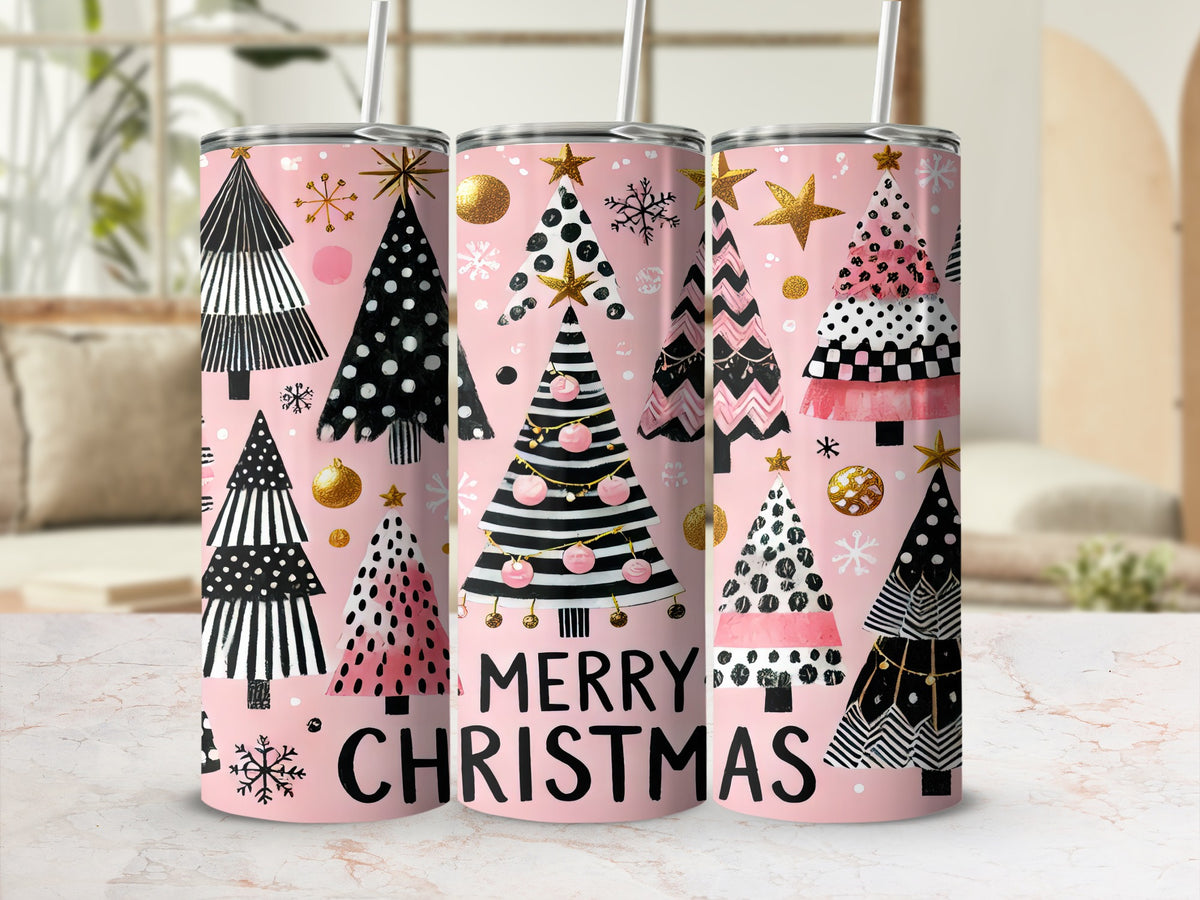 Three pink metal tumblers stand upright featuring patterned Christmas trees, gold stars, and the text Merry Christmas.