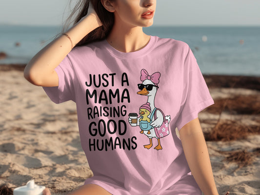 Pink t-shirt with a graphic of a mama duck and duckling and text.
