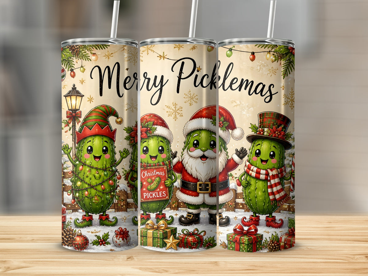 Three stainless steel tumblers with a Christmas pickle design featuring the text Merry Picklemas on a wooden surface.