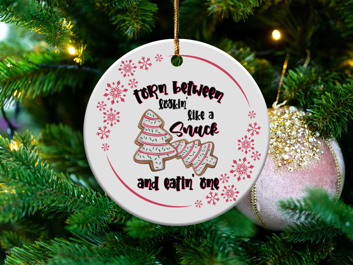 Round ornament with Christmas cookies, snowflakes, and text "Torn between lookin' like a snack and eatin' one."