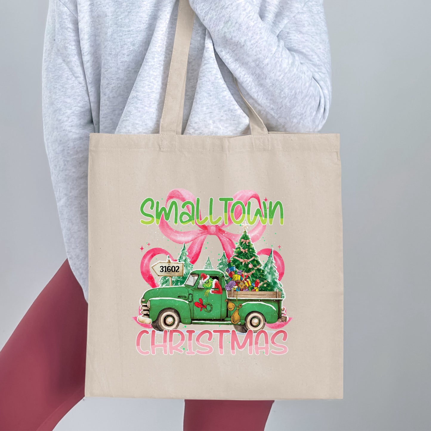 Tote bag with "Small Town Christmas" text, a green truck, and the Grinch.