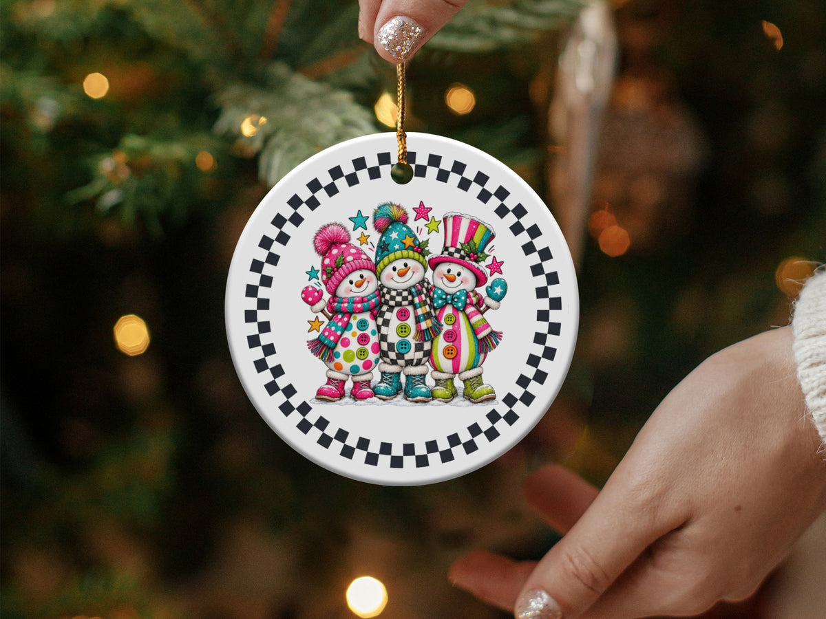 Ceramic Christmas ornament with three colorful snowmen and checkered border.