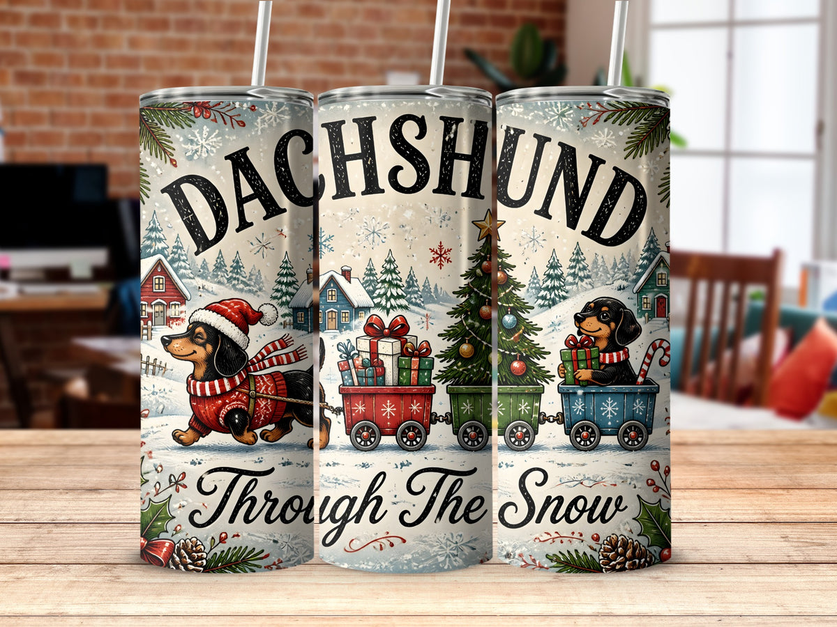 Three insulated travel tumblers display a Christmas dachshund design with snow scenes and the text Dachshund Through The Snow.
