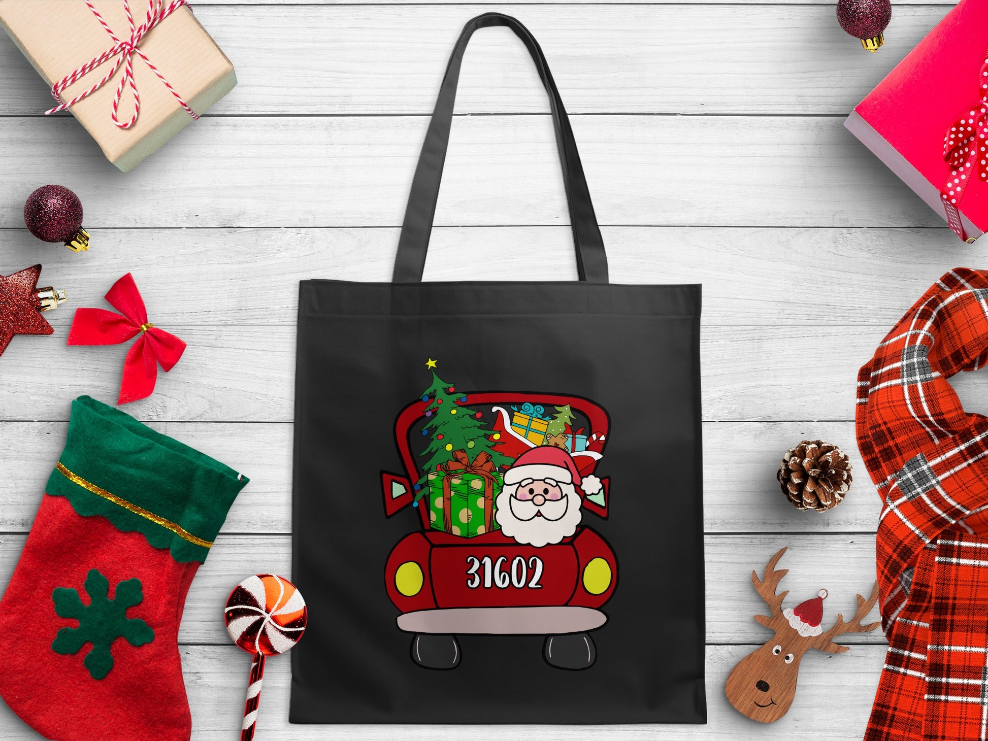 Black tote bag with Santa in a red truck graphic and the number 31602.