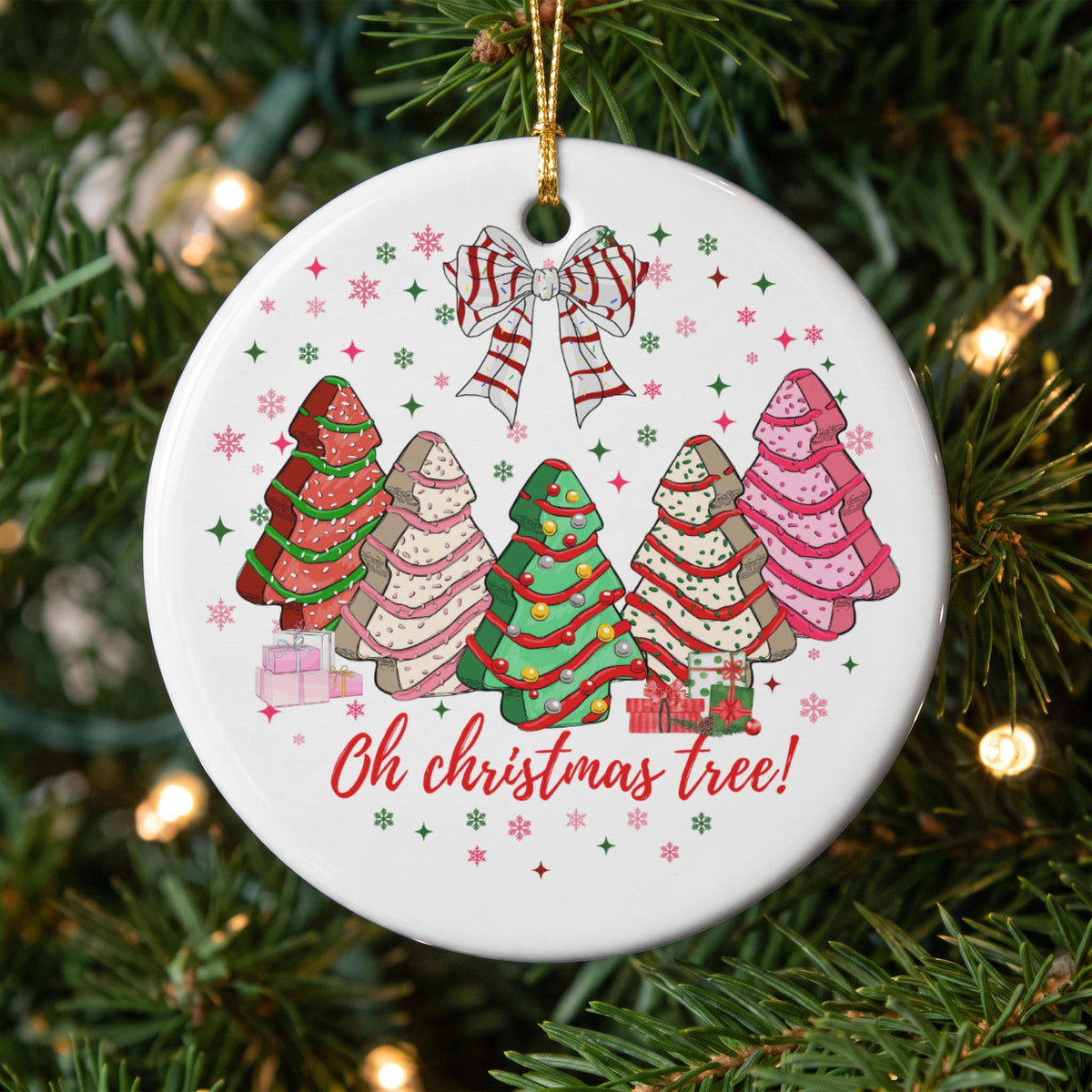 Round ornament with decorated Christmas trees and presents, says "Oh christmas tree!"