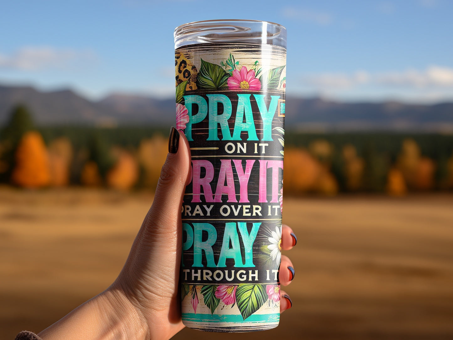 Tumbler with "Pray on it, Pray over it, Pray through it" text and floral pattern.