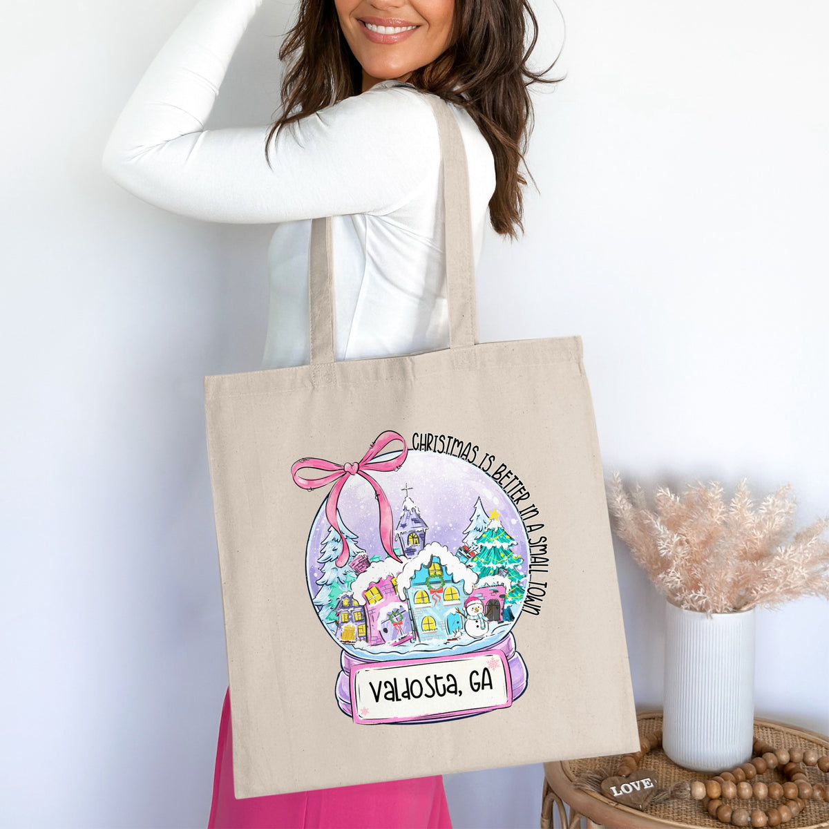 Tote bag with a watercolor snow globe design featuring a small town and "Valdosta, GA".