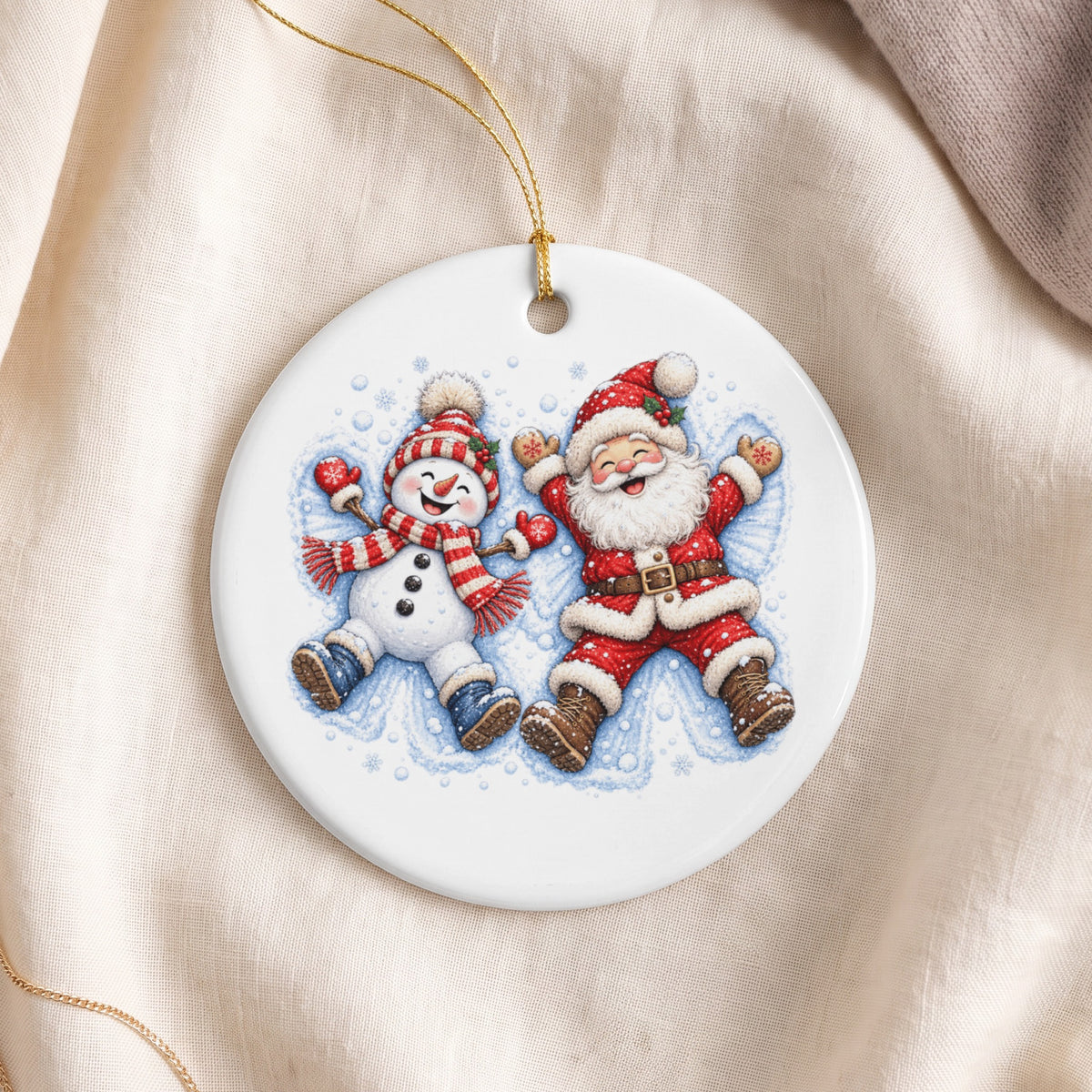 Round Christmas ornament depicting a happy snowman and Santa making snow angels.