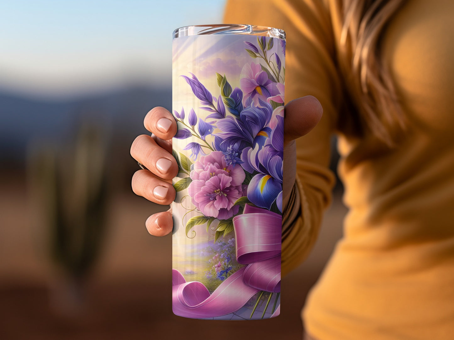 Pink and purple floral bouquet with pink ribbon on a tumbler.
