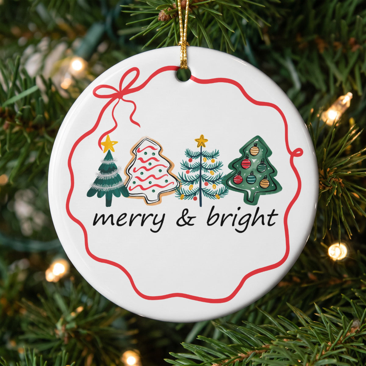 Round white ornament with a red ribbon border featuring Christmas trees and the words "merry & bright".