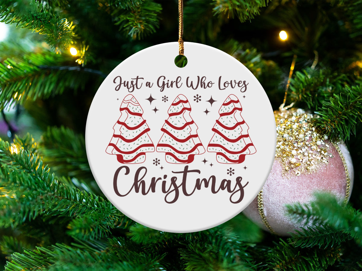 Round ceramic ornament with trees saying "Just a Girl Who Loves Christmas."