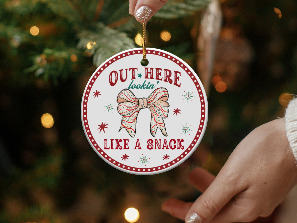 Round ornament with "Out Here Lookin' Like a Snack" text and a bow.