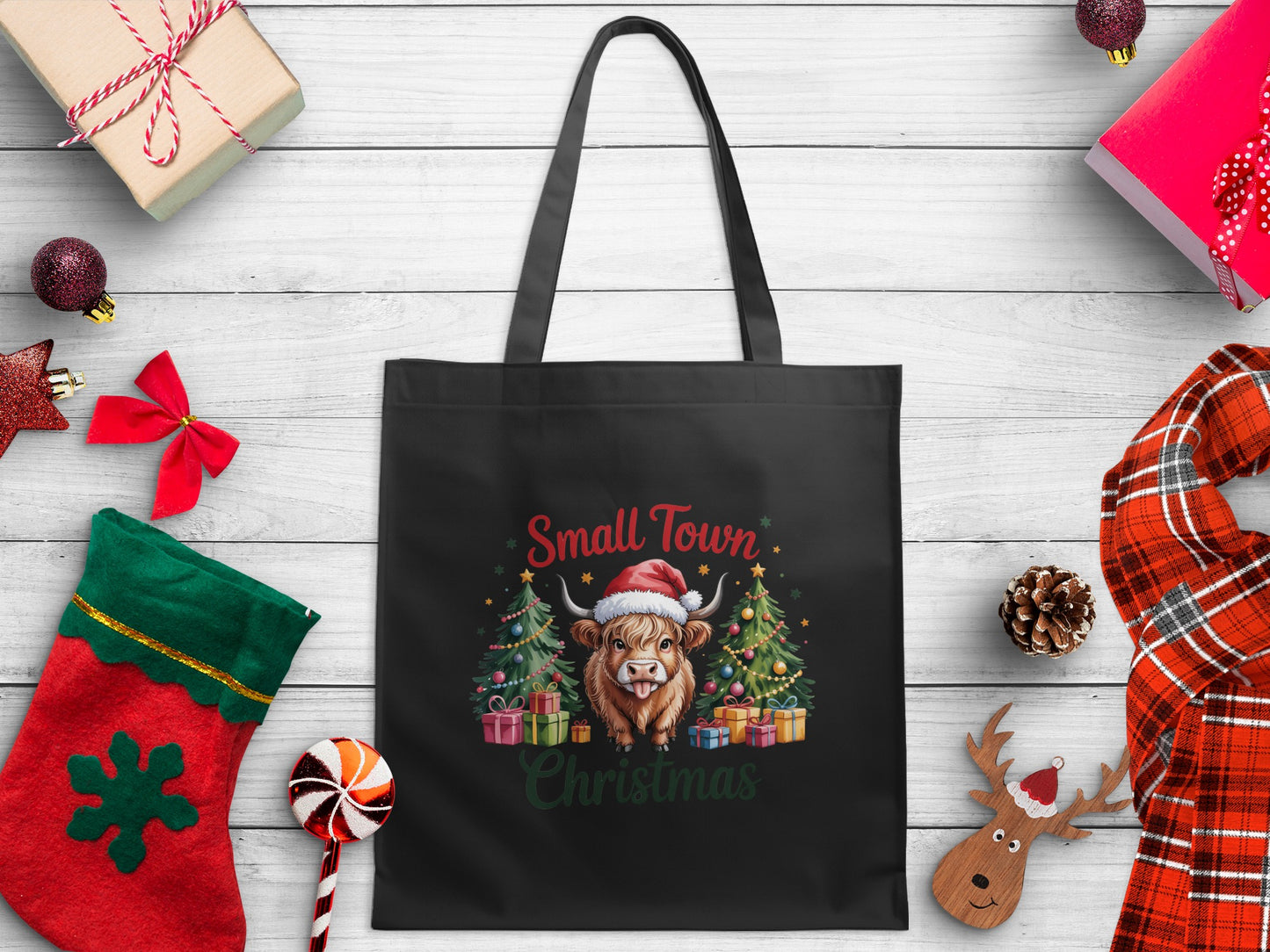 Black tote bag with a Highland cow and Christmas trees design: "Small Town Christmas"