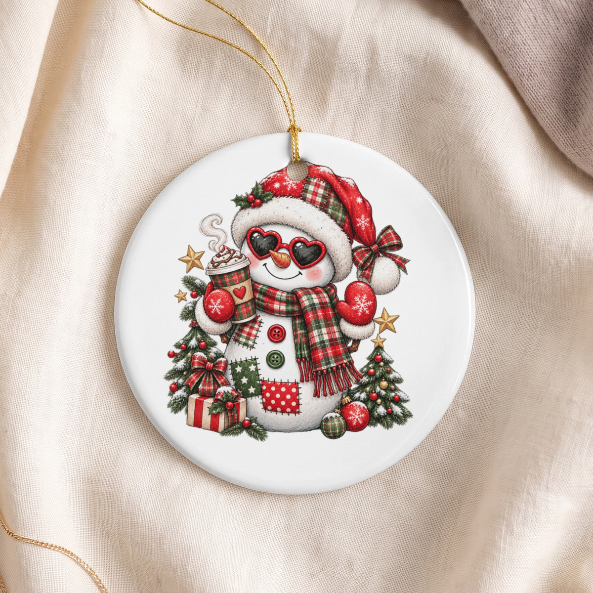 Christmas ornament featuring a patched snowman holding a hot cocoa cup.
