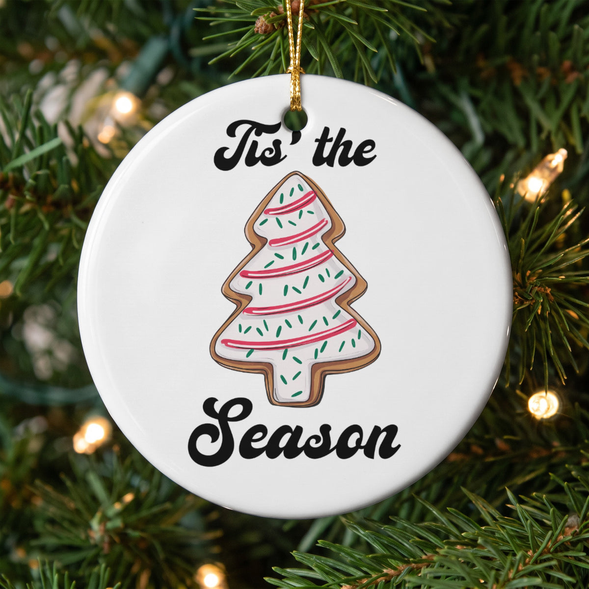 Tis the season Christmas tree cookie ornament on a decorated tree.