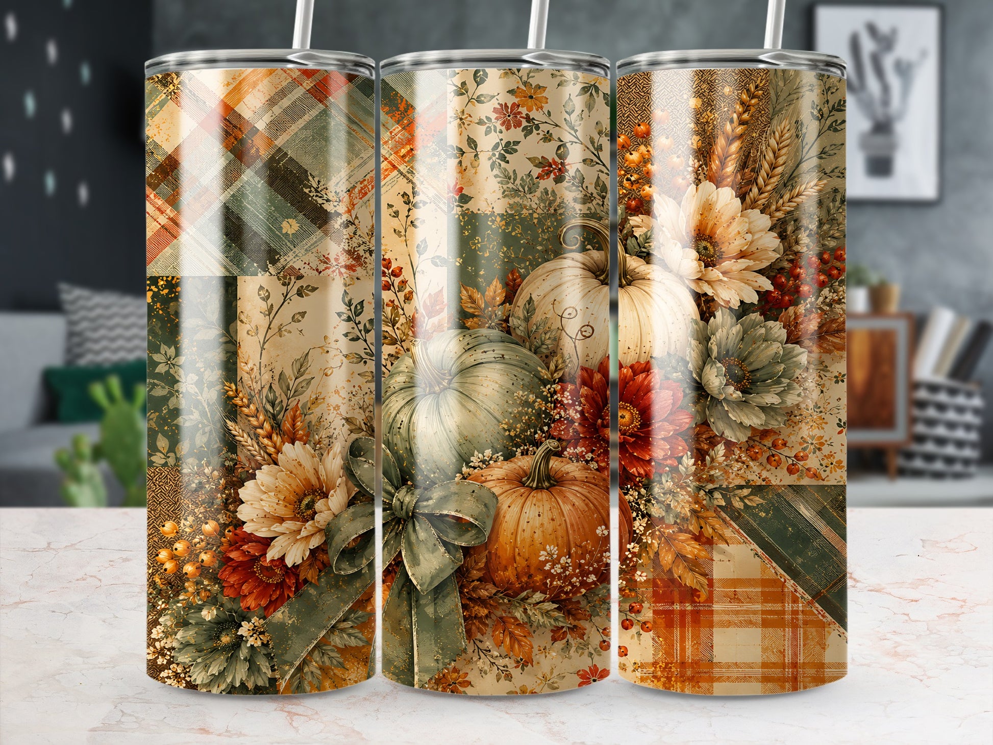 Three tumblers with a rustic autumn patchwork design featuring pumpkins, flowers, and plaid.