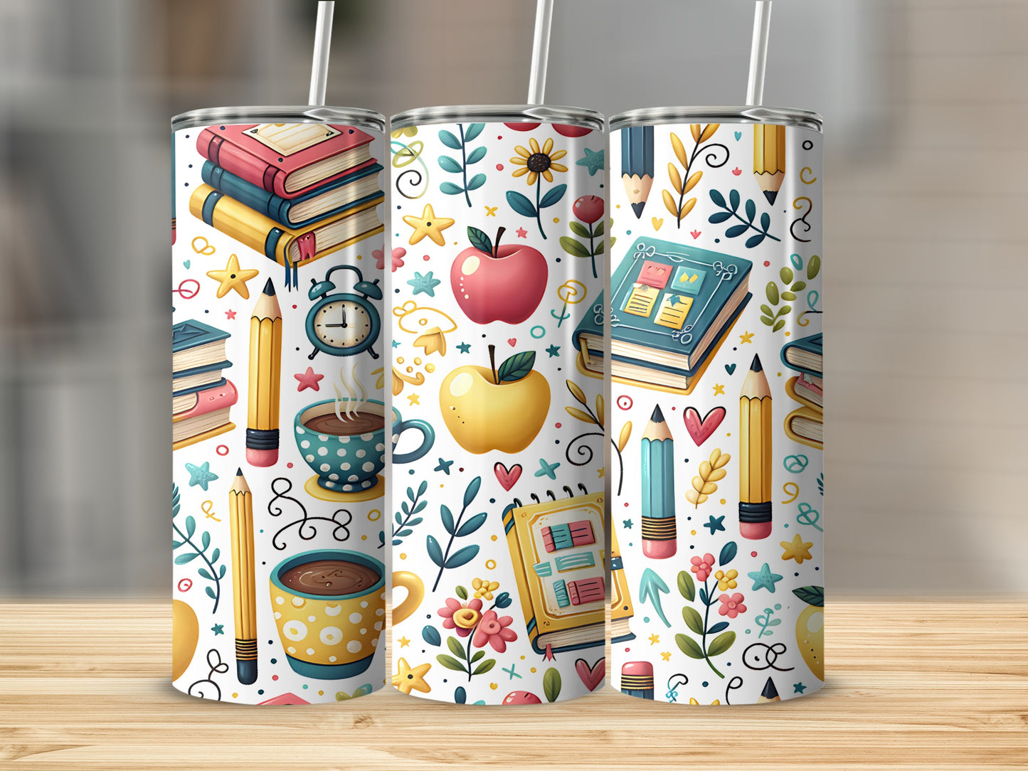 Three tumblers with a pattern of school supplies, fruits, and flowers.