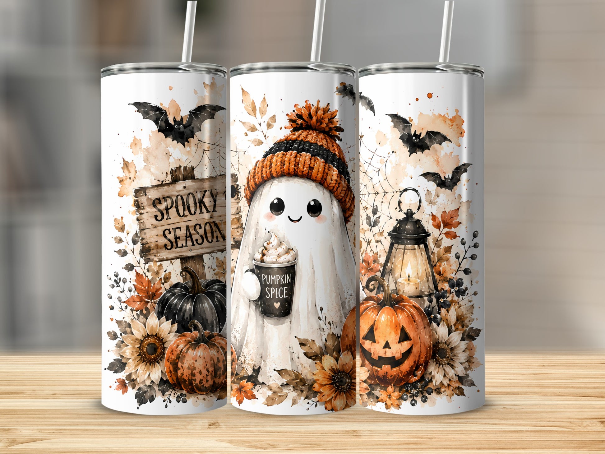 Three Halloween-themed tumblers with ghosts, bats, pumpkins, and sunflowers.